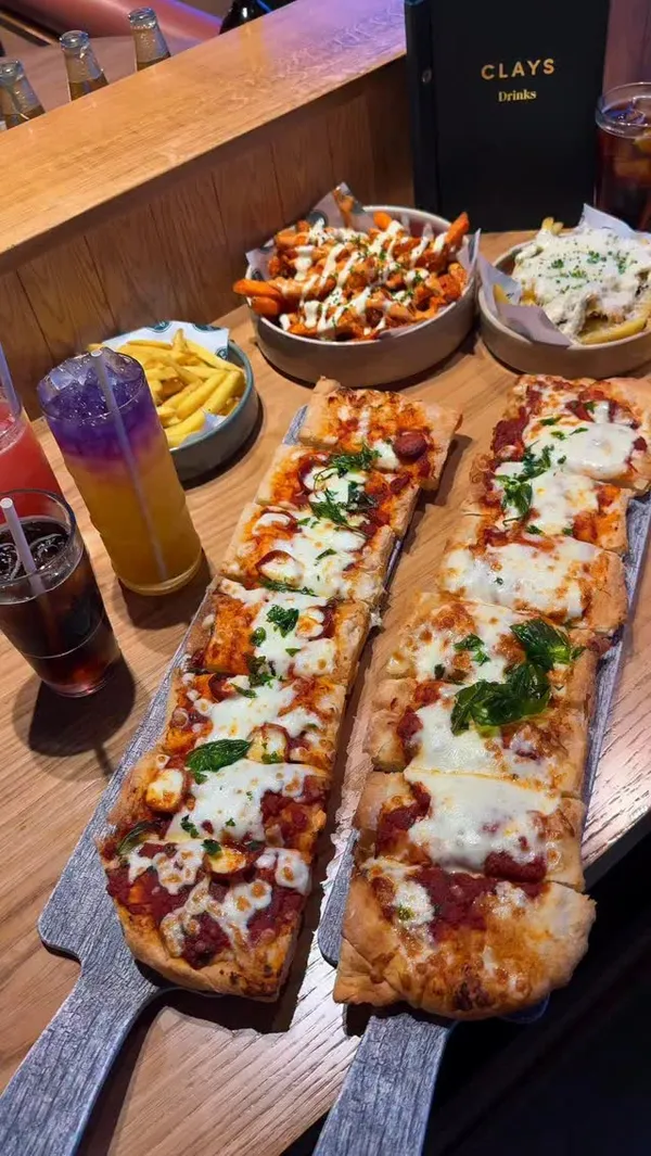 A vlog-style review of a visit to Clays, a venue offering virtual clay pigeon shooting. The video features the group participating in the games, enjoying pizzas and loaded fries, and provides an honest account of their experience, including a critique of the bottomless drinks service.