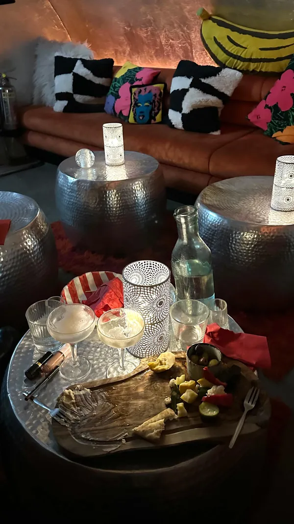 The video showcases The Little Scarlet Door, a bar in London. It features various shots of the bar's interior, cocktails (including close-ups), food platters, and the influencer enjoying the atmosphere. The overall mood is trendy and fun.  No specific dietary information is provided.