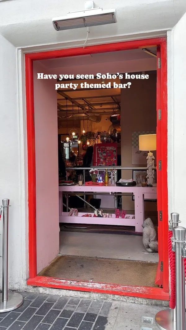 This video showcases The Little Scarlet Door, a bar in Soho, London, themed to resemble a house party.  The video shows various cocktails (including one with a marshmallow), sharing boards with olives, cheese, and pita bread, and the bar's interior and exterior.  The presentation focuses on the vibrant atmosphere and eclectic decor, highlighting the bar's unique aesthetic and social aspects. No specific dietary information is provided.