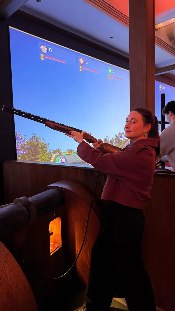 A high-energy vlog showcasing a visit to Clays, a competitive socialising venue in London. The video captures the exterior, the bar area, and the primary activity of interactive shooting games, highlighting the social and fun atmosphere of the experience.