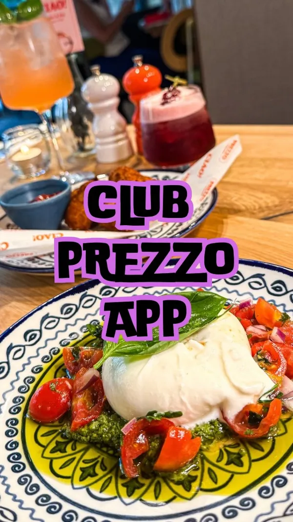 The video is a promotional piece for the Italian restaurant chain Prezzo, specifically advertising their new 'Club Prezzo' rewards app. It showcases a dining experience at one of their locations, featuring a variety of dishes and drinks. The video displays cocktails, olives, pancetta mac & cheese bites, a burrata salad, a chicken rigatoni dish, a baked spaghetti carbonara, and Nutella doughnut balls for dessert. The main focus is on the food and the benefits of using the app, such as 2-for-1 cocktails and discounts, which are highlighted through text overlays.