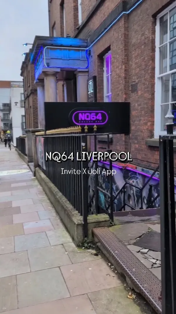 This video showcases NQ64 Liverpool, an arcade bar.  It features various arcade games (Pac-Man, Guitar Hero, Tetris, Mario Kart, Dance Dance Revolution, Space Invaders, and pinball), PlayStation 1 consoles with games like Spyro, and mocktails (specifically, the Mai Tai). The presentation emphasizes the nostalgic atmosphere and fun environment. No dietary information is explicitly provided.