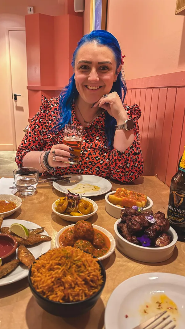The video showcases a visit to Chuku's, a Nigerian tapas restaurant in London. It begins with an exterior shot of the restaurant, followed by a woman entering. The interior is shown, highlighting the decor. The video then presents the menu and focuses on the food and drinks ordered: Star Lager, Nigerian Guinness, Zobo Wings, YoYo (whitebait), Banga Prawns, Suya Meatballs, Cassava & Ata Din Din, and Jollof Rice. The presentation emphasizes the variety and flavors of the dishes. The main focus is on showcasing the dining experience and the food.