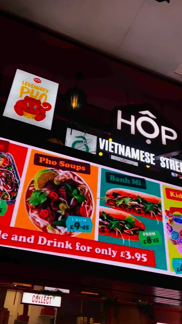 The video showcases HOP Vietnamese Street Eats at the Trafford Centre. It features various food items including Pho noodle soups, Banh Mi baguettes, rice bowls with peanut sauce, dumplings, and spring rolls.  The drinks include bubble tea and other beverages. The presentation emphasizes vibrant colors and close-ups of the food, highlighting its freshness and appetizing qualities.  Halal and plant-based options are mentioned. The main focus is on the food and its attractive presentation.