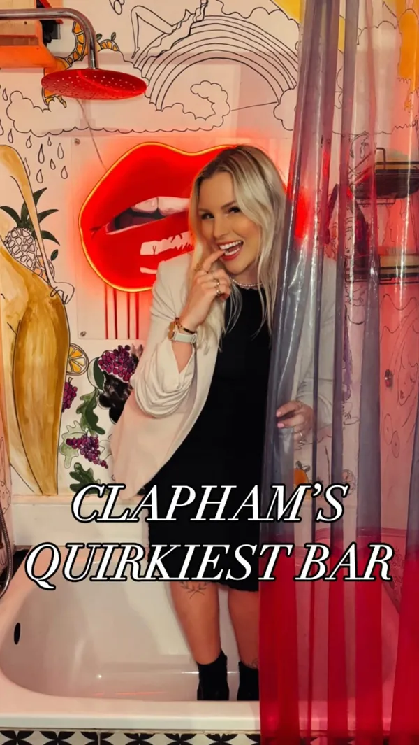 This video showcases The Little Orange Door, a bar in Clapham, London.  The video shows a woman enjoying various food and drink items, including a Negroni cocktail,  vegetable crudités with guacamole, tortilla chips, fries, and a vegan pizza with pumpkin, spinach, sweet onion, and vegan feta. The food is presented on various platters and in small bowls. The video emphasizes the bar's unique atmosphere and the quality of its vegan food options. 