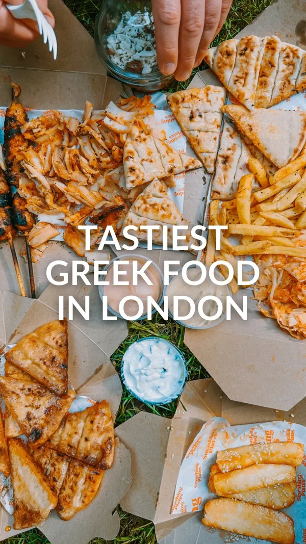 The video showcases a spread of food from Smashing Plates, a street food vendor in London. The setting is outdoors, on grass.  The food includes halloumi fries (smothered in honey), lamb skewers, pita bread, french fries, and a Greek salad.  The presentation is casual, with the food laid out on cardboard containers directly on the grass.  No dietary information is explicitly mentioned. The main focus is on the various food items and a quick dipping of a lamb skewer into a sauce.