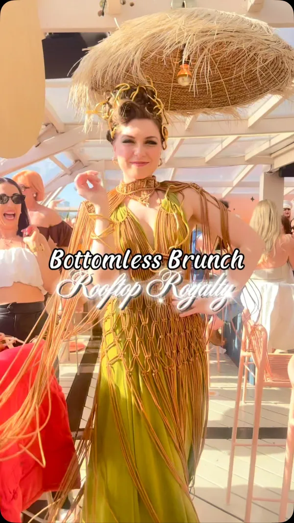 The video showcases a bottomless brunch event at Circe Waterloo rooftop venue. It features people enjoying cocktails, champagne, and food items like fries and flatbreads. The video includes shots of people toasting, dancing, a drag performer, and views of the London skyline. Text overlays highlight 'Bottomless Brunch', 'Rooftop Royalty', and the venue name.