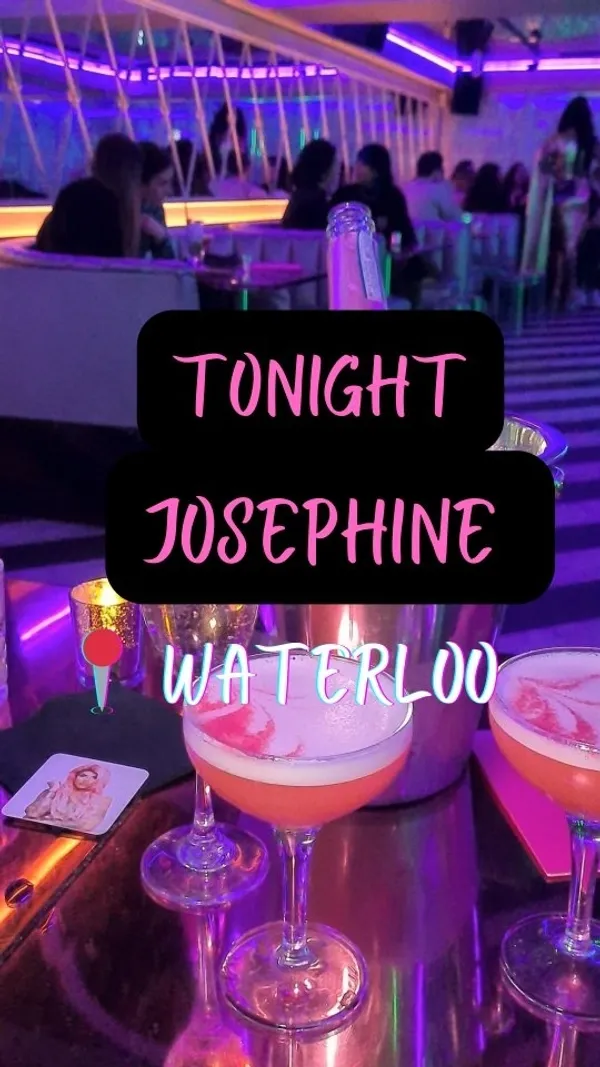 The video showcases Tonight Josephine, a bar in London. It features vibrant pink and purple lighting, a sleek bar area with various cocktails, and patrons enjoying the atmosphere.  Specific cocktails shown include a glowing green cocktail and a pink layered cocktail. The overall vibe is 80's themed and glamorous. 