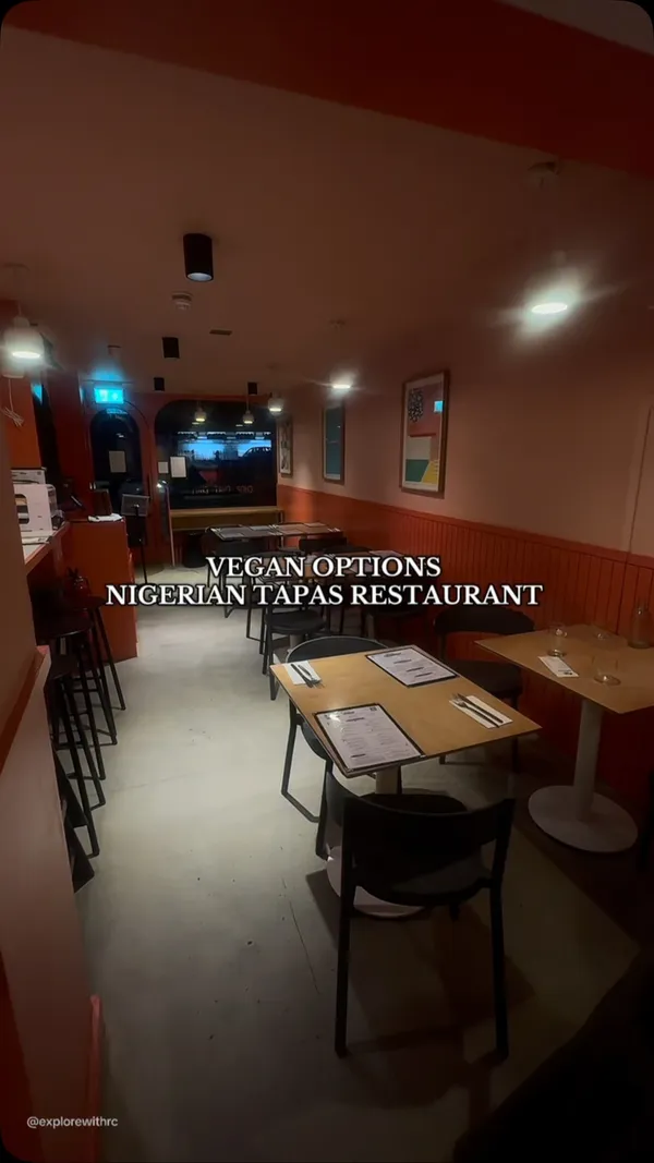 The video showcases a Nigerian tapas restaurant in London called "Chuku's." It highlights various vegan dishes including Jollof rice, Egusi bowl, Moi Moi, Dodo, Cassava & Ata Din Din, and Plantain Waffle.  The drinks featured are Chapman and Guinness. The food is presented on small plates, typical of tapas style. The video emphasizes the availability of vegan options and highlights the restaurant's ambiance.