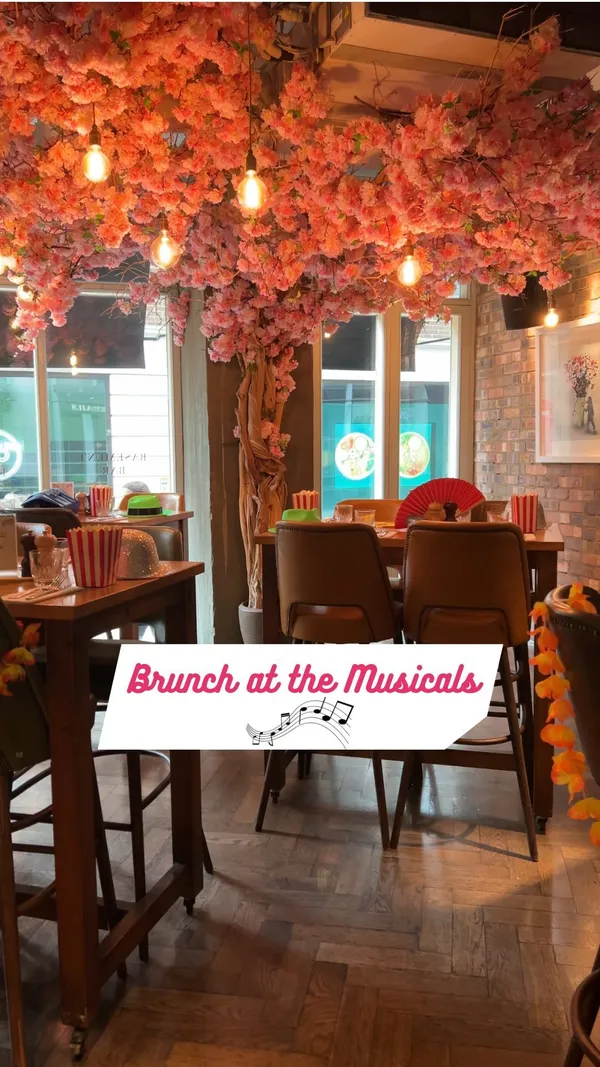 The video showcases Juno Rooms, a bar in London, hosting a "Brunch at the Musicals" event.  It features West End musical stars performing, along with scenes of food (steak with fries, cocktails), drinks (cocktails and beer), and patrons enjoying themselves.  The event includes bottomless drinks packages and is promoted through the DesignMyNight website.  No specific dietary information is provided.