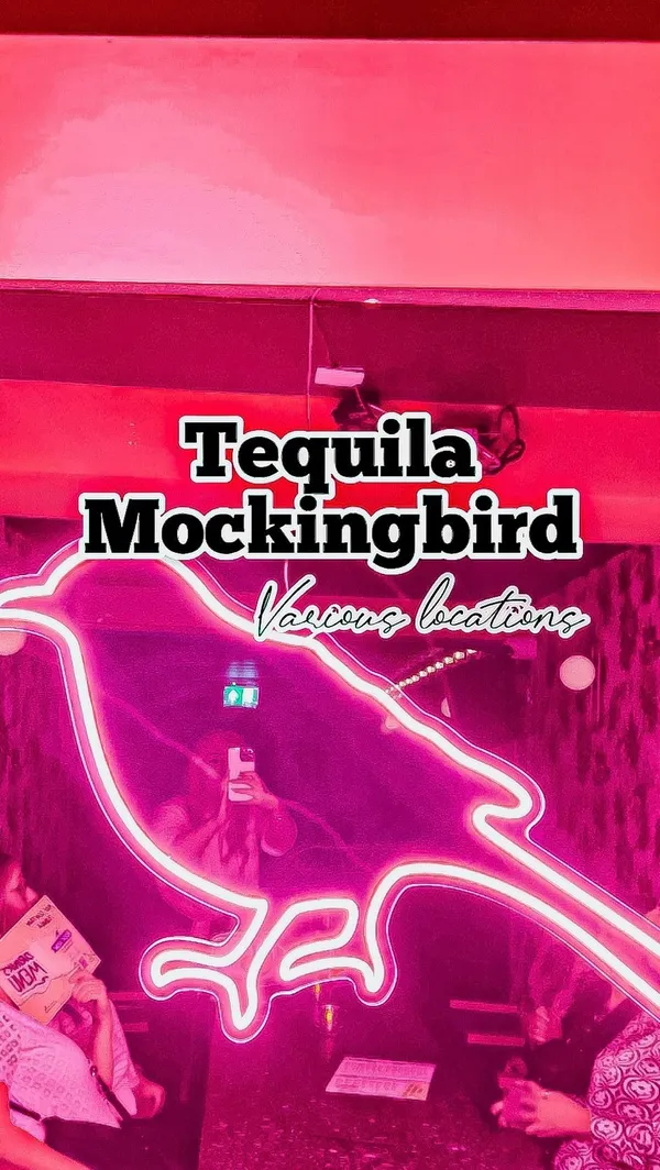 This video showcases a night out at Tequila Mockingbird, a cocktail bar with various locations.  The video shows two bartenders preparing cocktails, then cuts to shots of various cocktails being enjoyed by a group of friends.  Cocktails shown include Tropic Like It's Hot, Pornstar Martini, Foursome, Disney Princess, Espresso Martini, Summer Crush, Tangled Roots, and Midnight Kiss. The cocktails are presented in various glasses, some garnished with fruit and flowers. No dietary information is provided. The main focus is on the cocktails and the lively atmosphere of the bar.