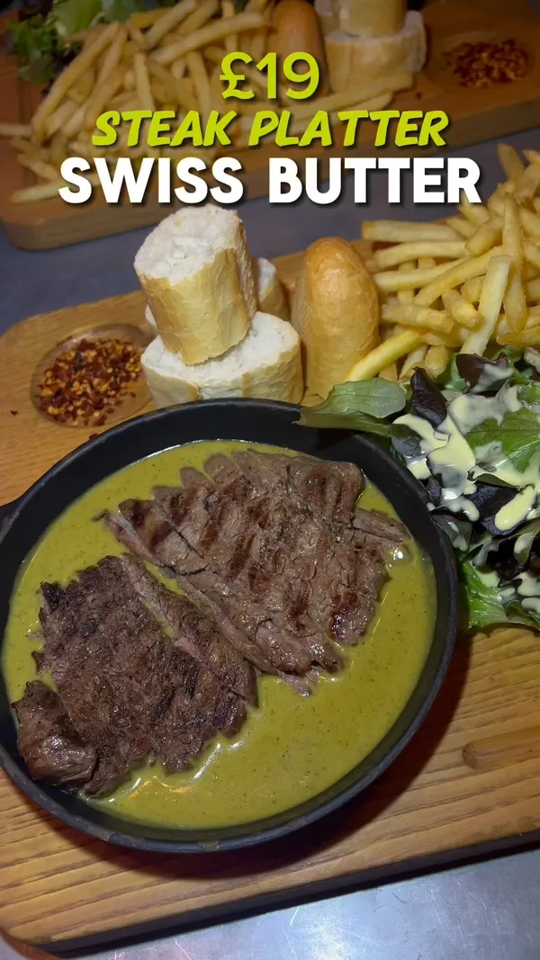 The video reviews Swiss Butter restaurant in London, showcasing their steak platter with Swiss butter sauce. The platter includes steak, fries, bread, and salad. The reviewer highlights the tenderness of the steak, the abundance of food, and the unique sour and mustardy flavor of the sauce.  The restaurant's atmosphere is described as loud and rushed. The video emphasizes the food quality and presentation.