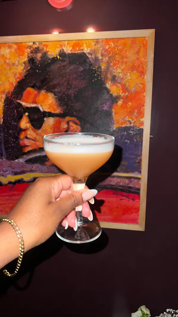 This video showcases The Little Violet Door, a bar in Soho, London.  The video features two women enjoying cocktails and food (chicken tenders, fries, and a chicken sandwich). The bar's interior design is shown, with a unique theme based on a fictional flat share. The DJ is also highlighted, and the overall focus is on promoting the bar's atmosphere and drinks.