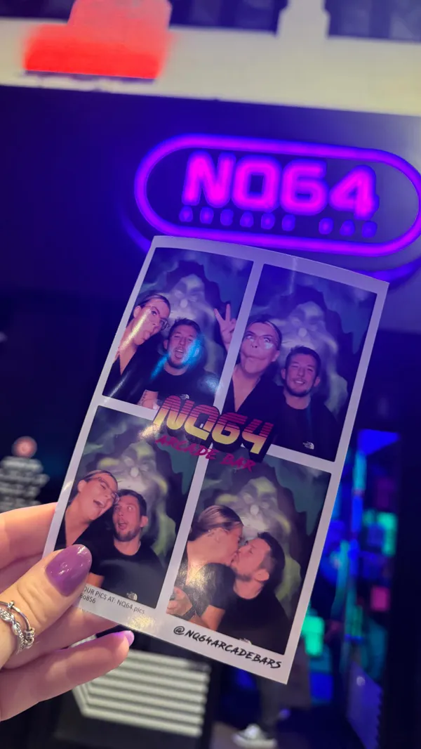 The video showcases a night out at NQ64 Arcade Bar in Cardiff. It features various arcade games, neon lighting, and brightly colored cocktails. The main focus is on the experience of visiting the bar, highlighting the atmosphere, drinks, and games. Specific drinks shown include a flaming cocktail and a green-colored cocktail with a glowing ice cube. Dietary information is not specified.