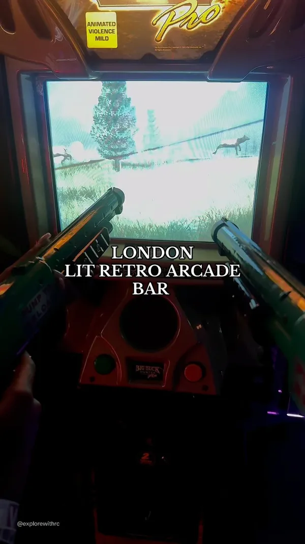 The video showcases NQ64 Soho, a retro arcade bar in London. It highlights the bar's atmosphere, various arcade games, and a selection of cocktails. The drinks shown include a flaming cocktail in a mason jar, another cocktail with ice and pineapple, and a blue-colored soda. The video also features a photo booth and VIP wristbands. The main focus is on the overall experience of the bar, emphasizing its fun, competitive, and social aspects.