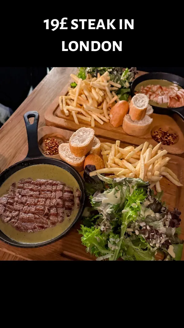 The video showcases a meal deal from Swiss Butter restaurant in London. It features various dishes including steak and chicken with a green sauce, fries, salad, bread, and two desserts (chocolate lava cake and caramel French toast). The food is presented on wooden boards with individual mini-pans. The restaurant's interior is also briefly shown.