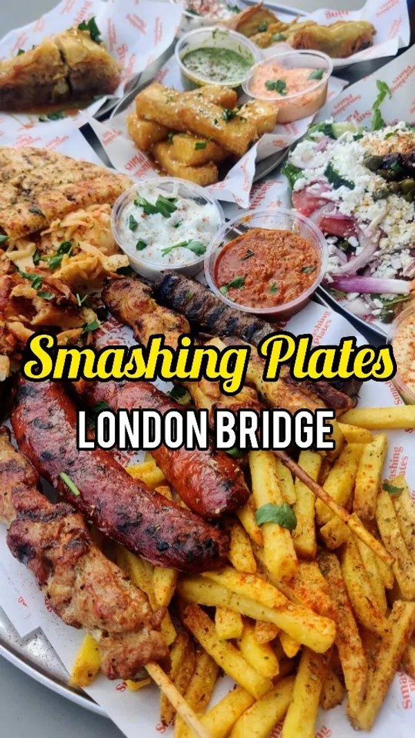 The video showcases a meal at Smashing Plates, a Greek restaurant in London Bridge.  It features various dishes, including a grilled feast (meat skewers, sausages, chicken, fries), the Olympus salad, feta and spinach cheese rolls, halloumi fries, and baklava. The presentation emphasizes abundant portions and vibrant colors. Dietary information mentions veggie and vegan options. The main focus is on showcasing the variety and deliciousness of the food.