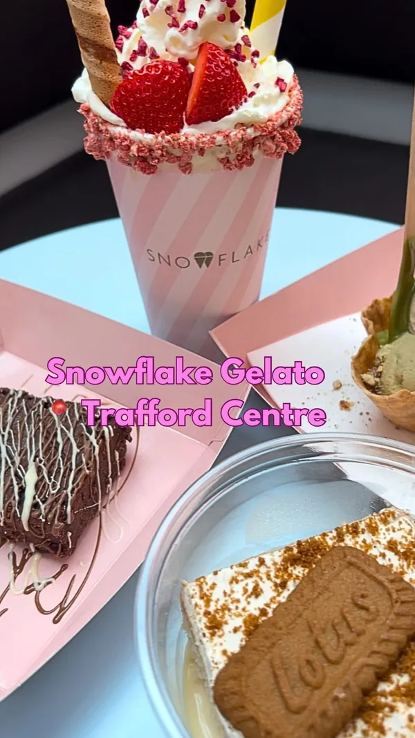 The video showcases Snowflake Gelato, located in the Trafford Centre. It highlights various desserts, including a strawberry and cream milkshake, pistachio gelato in a waffle basket, Lotus milk cake, and a brownie. The presentation emphasizes the visually appealing aspects of each dessert, with close-up shots and overhead shots. No specific dietary information is provided. The primary focus is on showcasing the various desserts and the inviting ambiance of the cafe.