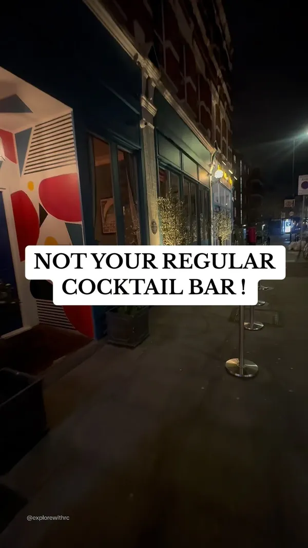 The video showcases The Little Blue Door, a cocktail bar in West London.  It presents various areas of the bar, including a living room-style area with projected movies, a games room, and a uniquely decorated laundry room.  The food shown includes steak with fries and a unique cocktail presentation is highlighted.  The bar's atmosphere and unique design elements are emphasized.