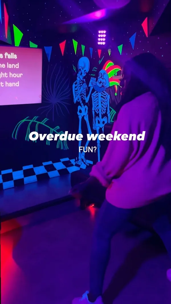 The video showcases Bat and Ball, a multi-play bar in Westfield Stratford City, London. It features various activities like darts, karaoke, and ping pong. The food and drinks shown include cocktails (two different types are shown), and the overall atmosphere is lively and vibrant. The video highlights the bar's features, games, and ordering system, emphasizing the social and fun aspects of the venue.