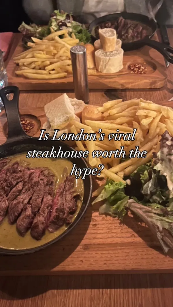 The video showcases a meal at Swiss Butter restaurant in London. It features two beef filet dishes served with Swiss butter sauce, fries, baguette, and salad.  A molten chocolate dessert is also shown. The restaurant's ambiance is briefly captured at the end.  The video primarily focuses on the food and drink, with shots of the meal preparation and consumption.