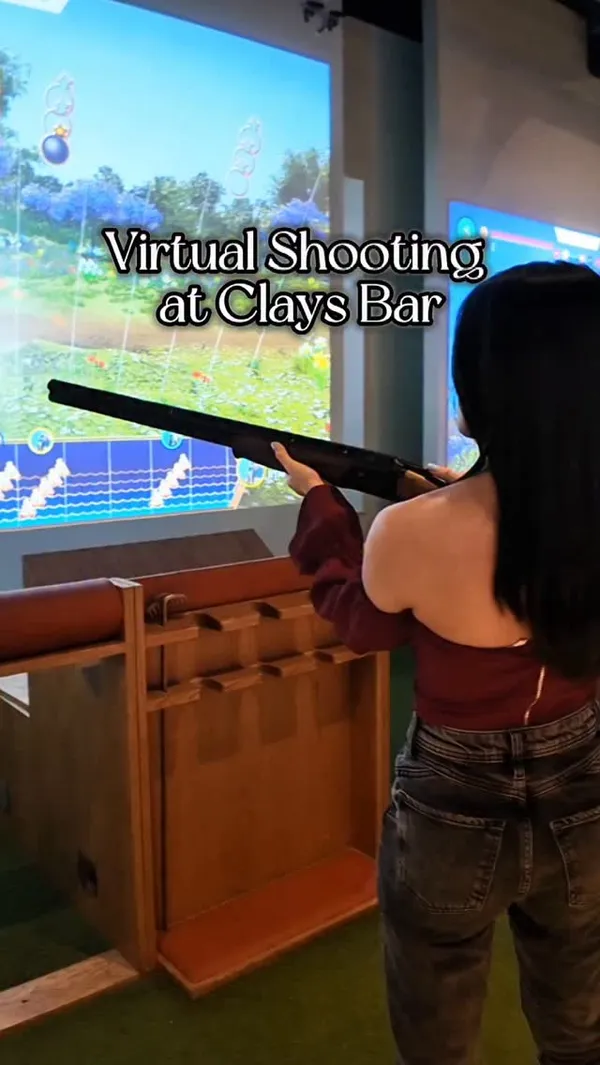 The video features a visit to Clays Bar, highlighting the virtual shooting arcade experience and the cocktail menu. It showcases the interior of the venue, the gaming stations, and the drinks, positioning it as a fun spot for social outings like date nights or after-work drinks.