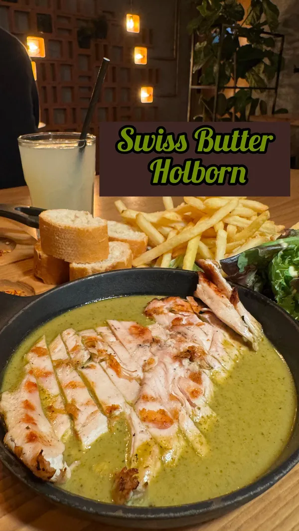 This video showcases Swiss Butter, a steakhouse in Holborn.  It features the preparation of food and drinks, including a ribeye steak, chicken dish, Pan Perdu, molten chocolate cake, and lemonade. The food is presented in visually appealing ways, with close-ups and overhead shots used effectively.  No specific dietary information is provided.