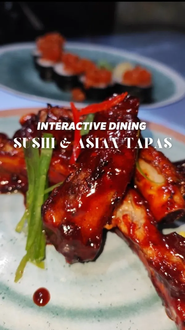 The video showcases Inamo, a Pan-Asian restaurant and bar in London. It highlights the restaurant's interactive table ordering system, showing various dishes such as spicy ribs, noodles, sushi, and a chocolate lava cake. The video emphasizes the unique dining experience, focusing on the visual appeal of the food and the technology used for ordering.  No specific dietary information is provided.