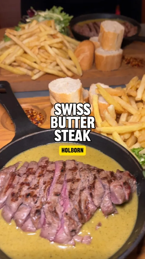 The video showcases a steak meal at Swiss Butter restaurant in Holborn, London.  The meal includes a steak in a green sauce, served in a sizzling pan, with french fries and a side salad. The presentation is visually appealing, with a focus on the steak and its sauce. The video emphasizes the affordability of the meal at £19.  No dietary information is explicitly provided.