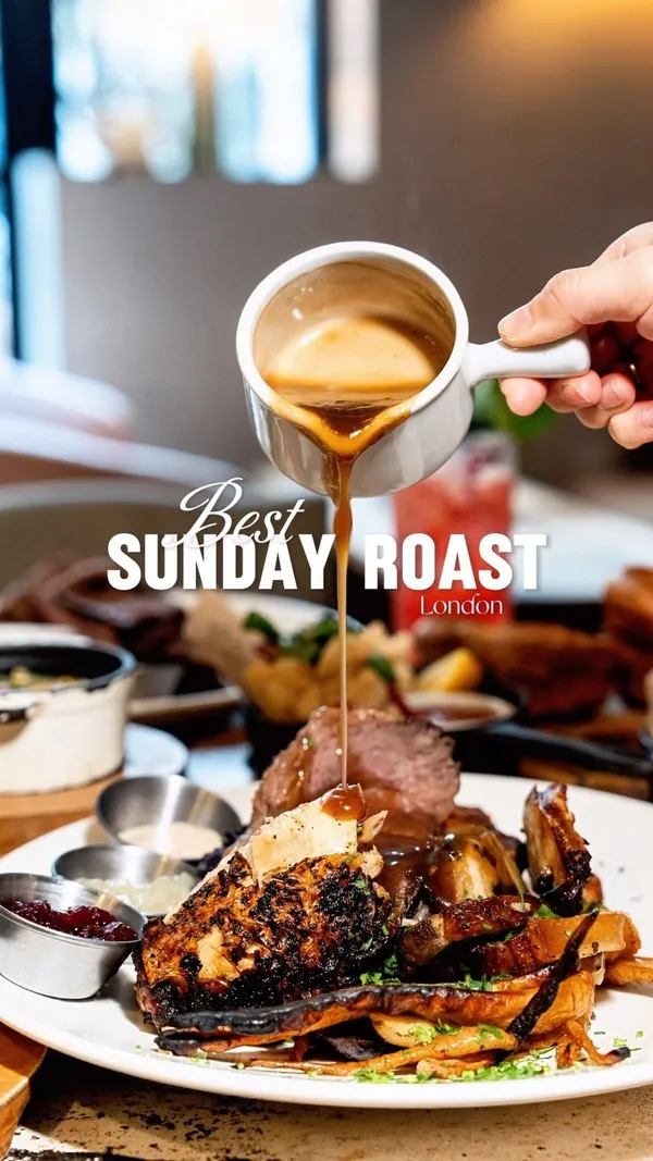 The video showcases a Sunday roast at The Address Bar in Canary Wharf, London.  It features various dishes, including roast beef, mixed roast, buttermilk fried chicken tenders, crispy squid, and Shetland mussels.  The drinks shown are a Mango & Coconut Margarita and a House Lemonade cocktail. The food is presented attractively on plates and in small dishes, with overhead and close-up shots emphasizing the textures and colors. The setting is a modern, spacious restaurant with ample natural lighting.