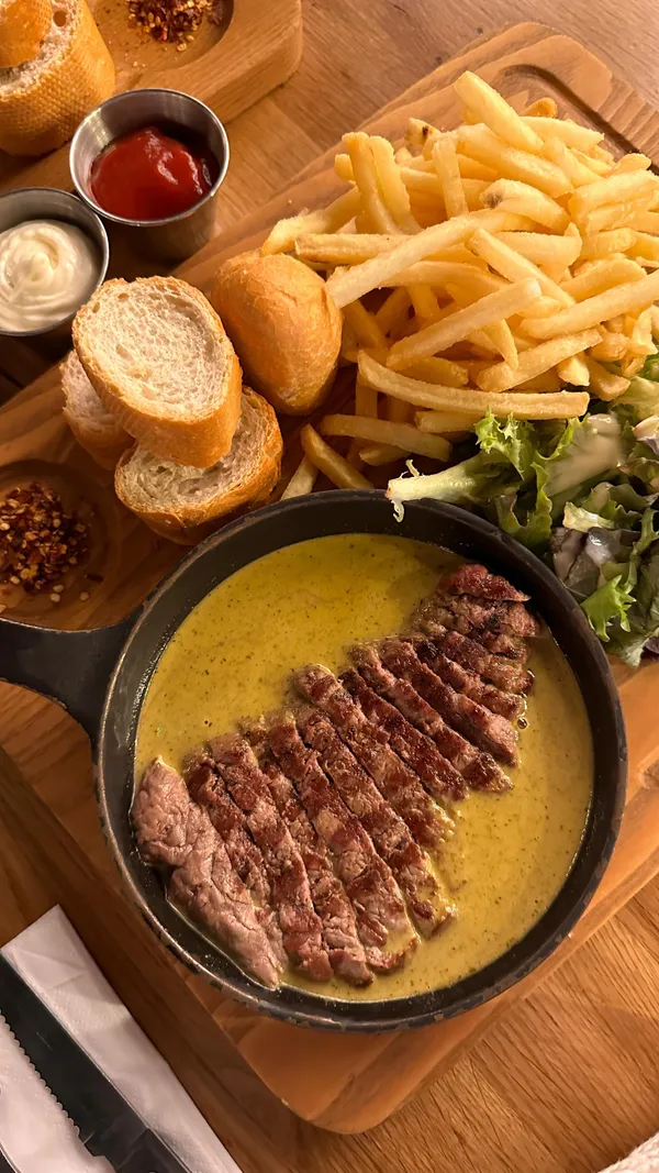 The video showcases Swiss Butter, a London restaurant, featuring its three main dishes: beef, chicken, and salmon, all served with sides for £19.  The video includes shots of the restaurant's exterior and interior, along with close-ups of the food, including a chocolate dessert.  No specific dietary information is provided.