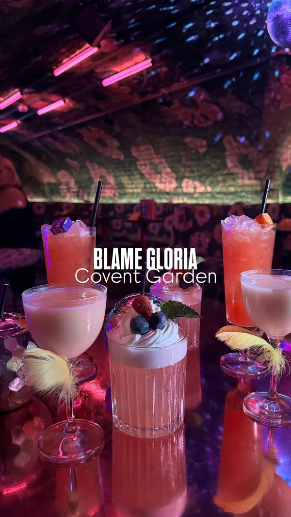 The video showcases a night out at Blame Gloria in Covent Garden, London. It features various cocktails, including those with whipped cream and berries, and tall, colourful drinks. The presentation emphasizes vibrant colours and playful garnishes.  The main focus is on the atmosphere and cocktails of the bar, with friends enjoying drinks together. No specific dietary information is provided.