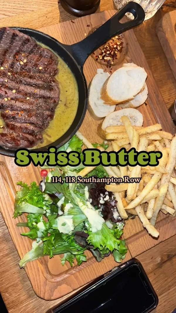 The video showcases a Valentine's Day dinner at Swiss Butter restaurant in London. It features various dishes including beef filet and salmon with a green sauce, french fries, baguette, salad, molten chocolate dessert, and pain perdu.  The food is presented on wooden platters. The video focuses primarily on the meal, with shots of the food and drinks, and the influencer enjoying their meal.