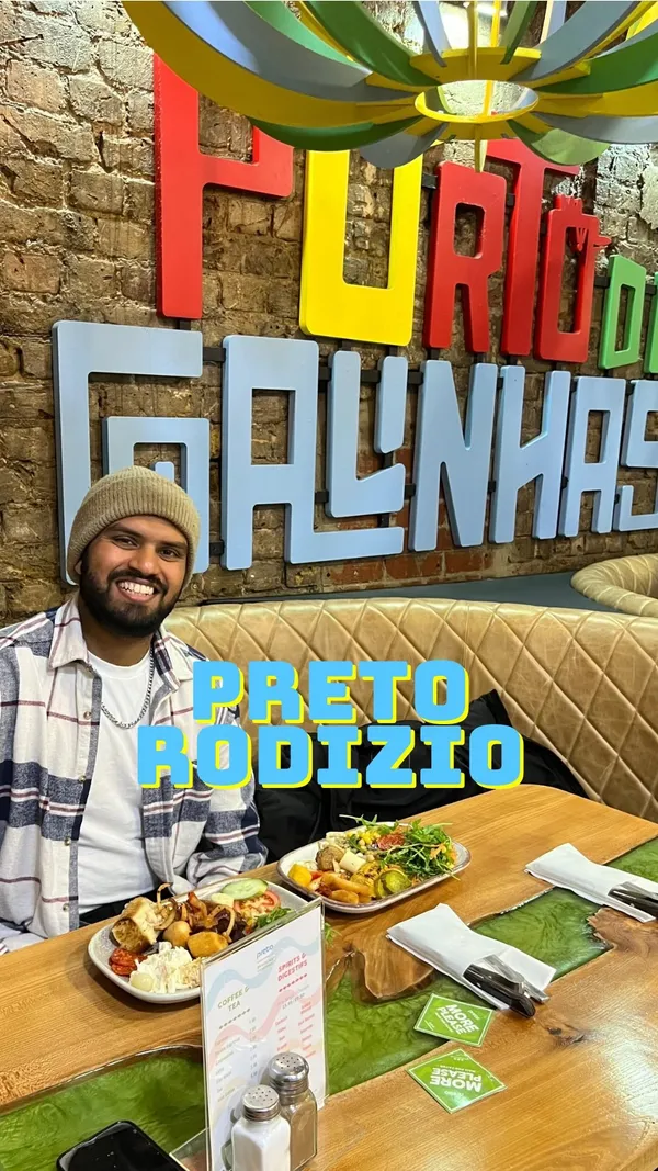 This video showcases Preto Restaurant, focusing on their Rodizio experience. The setting is a modern Brazilian restaurant. The food shown includes a variety of buffet items (salads, roasted vegetables, fries, etc.), and various grilled meats served table-side on skewers. The presentation is visually appealing, highlighting the freshness and variety. Halal meat is mentioned as available at certain locations. The video mainly focuses on the sheer variety and abundance of food available.