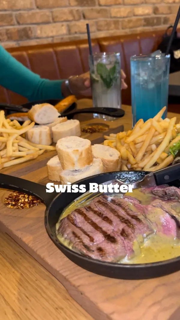 The video showcases Swiss Butter restaurant in Holborn, London. It features various dishes, including beef fillet, ribeye steak, salmon, and chicken breast, all prepared with a Swiss butter sauce.  Desserts such as molten chocolate cake and pain perdu are also highlighted. The video includes shots of cocktails and the restaurant's interior and exterior.  No specific dietary information is provided.