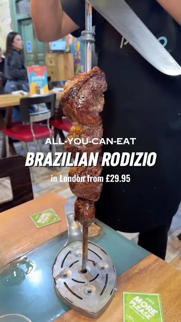 This video showcases Preto Restaurant, a Brazilian steakhouse in London, offering an all-you-can-eat rodizio. The video highlights various cuts of grilled meats, a large salad bar with 25+ sides, and drinks. The food is presented on plates and directly from the skewers.  No specific dietary information is given, besides the mention of Halal options at specific locations. The main focus is on the abundance and variety of food offered.