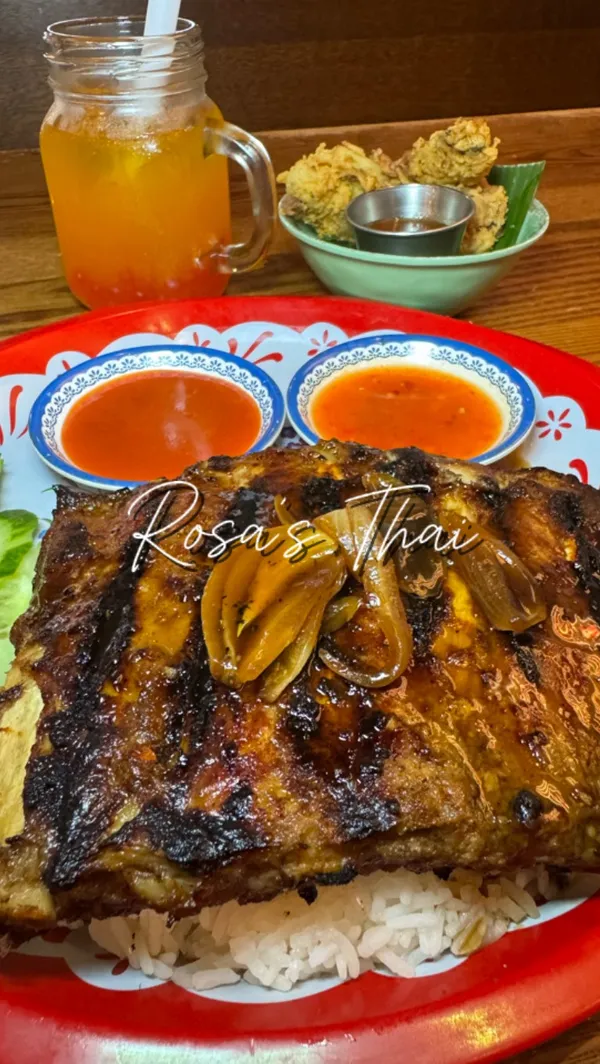 The video provides a tour of a visit to Rosa's Thai restaurant in Edinburgh. It begins with an exterior shot, moves inside to show the decor and ambiance, and then focuses on the menu, particularly the "Little Rosa's" kids' menu. Several dishes are showcased, including a child's meal of Thai fried chicken nuggets with jasmine rice and vegetables, pumpkin crackers, glazed pork ribs, Thai fried chicken wings, and a dessert of vanilla ice cream with strawberry popping boba. The video also shows various drinks, including a bubble tea. The overall theme is a family-friendly lunch experience.