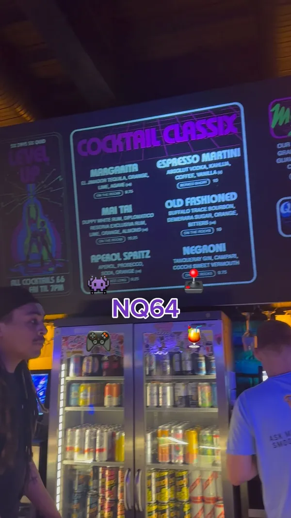 The video showcases NQ64, a bar in Leeds with a retro arcade theme. It features various cocktails (e.g., Mad Max Zombie, Kong Island Iced Tea, Quick Revive No.5), and several arcade games (e.g., Time Crisis II, Pac-Man, Simpsons Arcade). The drinks are presented in unique glasses and garnished creatively. The main focus is to showcase the bar's atmosphere and unique features, combining cocktails and classic arcade games. 