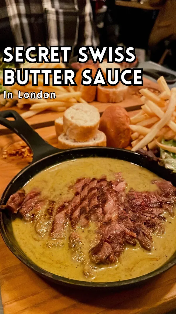 This video showcases Swiss Butter, a restaurant in Holborn, London. The video primarily focuses on their ribeye steak dish, which is served in an iron skillet with their signature Swiss butter sauce.  The sauce is described as tangy and buttery.  Accompanying sides include fries, salad, and baguette.  The video also shows their chocolate fondant and pain perdu desserts.  The overall tone of the video is positive and appetizing.