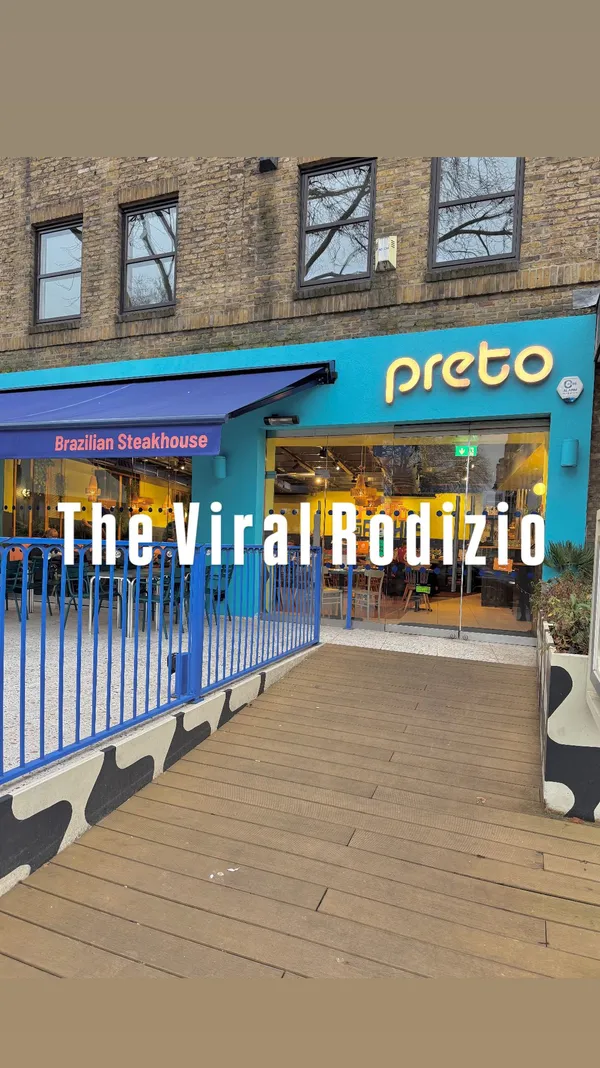 This video showcases Preto Restaurant, a Brazilian Churrascaria in Angel, London. It features a buffet of hot and cold Brazilian dishes, including various salads, rice, fries, and stews. The main focus is the unlimited meat served tableside on skewers. The video also shows desserts, including ice cream and cakes.  The video highlights the 'More Please'/'I'm Full' card system for managing meat service. 