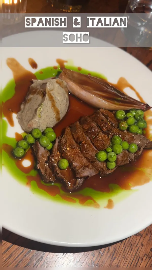 This video showcases a dinner experience at Ember Yard restaurant in Soho, London.  The video highlights various dishes including Grilled Lamb Fillet, Yellowfin Tuna, Grilled Asparagus, Grilled Iberico, and Jamon Iberico De Bellota, alongside cocktails and wine.  The presentation of each dish is emphasized through close-up shots, showcasing the plating and visual appeal.  No specific dietary information is provided. The main focus is on presenting the food and ambiance of the restaurant.