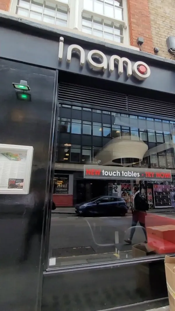 This video showcases Inamo restaurant in London's Soho, highlighting its interactive tables. The video shows customers ordering food and playing games on the tables. Specific dishes shown include the East Meets West Roll (sushi), and some meatball-like appetizers. The presentation emphasizes the technological aspect of the dining experience, with a focus on the digital menu and table games.  No dietary information is explicitly provided.