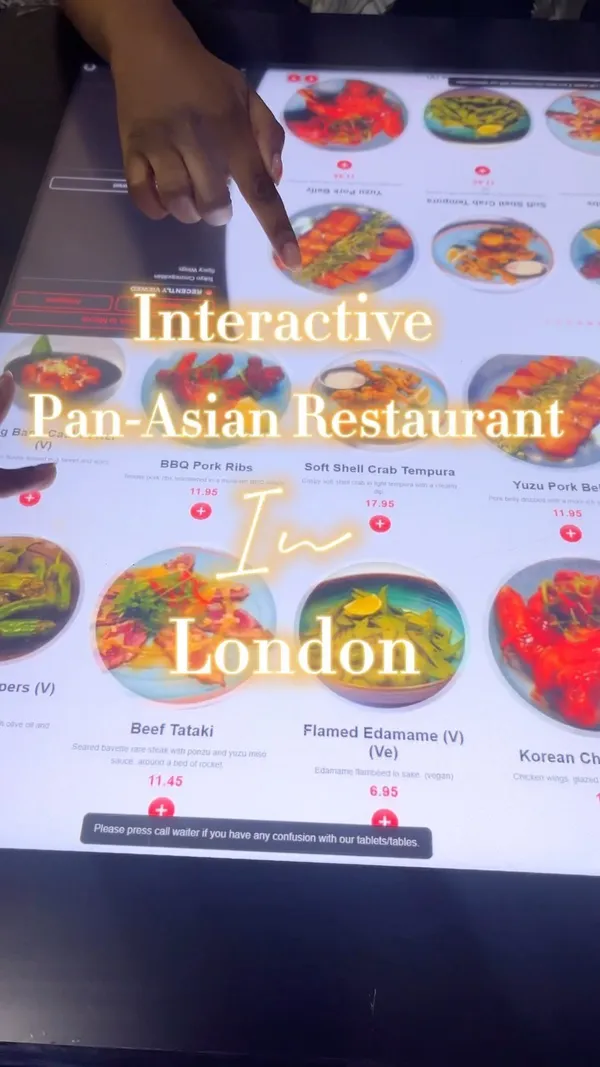 The video showcases Inamo restaurant in Covent Garden, London, highlighting its interactive tables.  It features various Pan-Asian dishes, including BBQ pork ribs, soft shell crab tempura, sushi rolls (Heaven & Hell, Unagi), sweet and sour chicken, and bang bang cauliflower. A guava juice is also shown. The food is presented on stylish plates and the restaurant has a modern, vibrant interior. Dietary information isn't explicitly provided. The main focus is showcasing the food, restaurant ambience and interactive table experience.