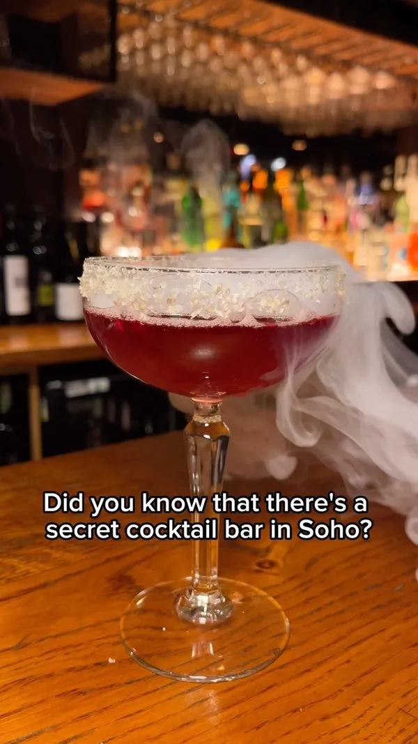 The video showcases Ember Bar, a hidden cocktail bar located beneath an award-winning restaurant in Soho, London. It highlights the bar's unique cocktails with theatrical presentations.  Specific drinks shown include an Espresso Martini, Ember Garden, Caipirinha, Smoky Hibiscus Margarita, and a Vintage Negroni. The presentation focuses on visually appealing cocktails with garnishes and occasional smoke effects. No dietary information is explicitly provided. The main focus is on showcasing the bar's atmosphere and cocktail selection.