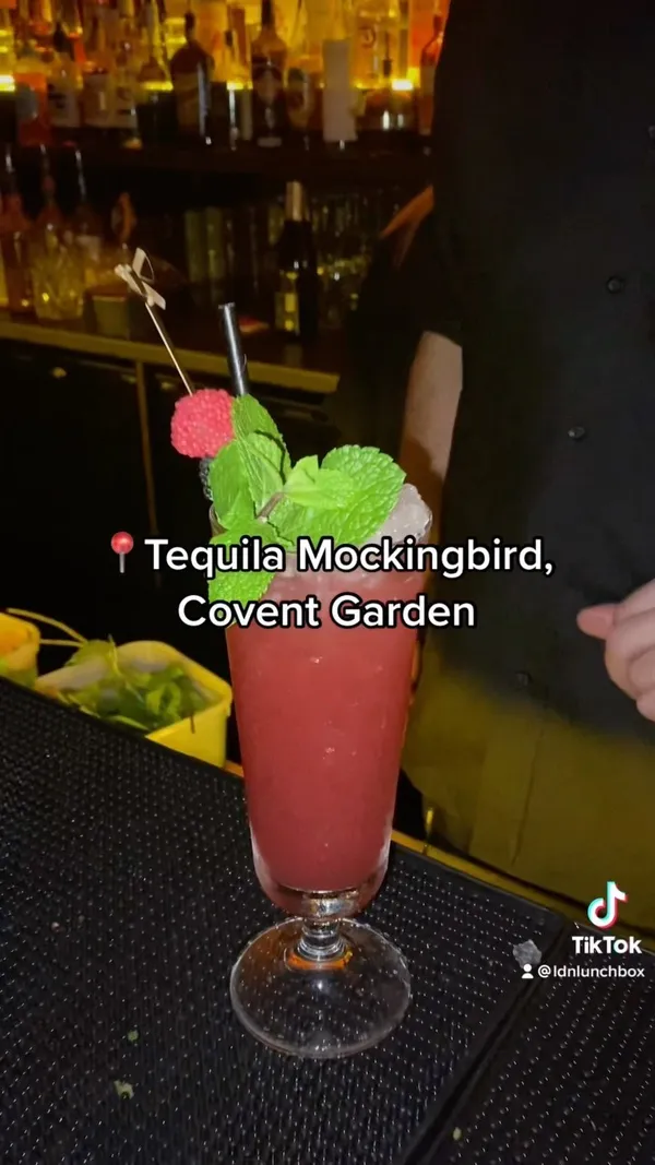 This TikTok video showcases Tequila Mockingbird, a bar in Covent Garden, London. The video highlights the bar's Halloween decorations, showcasing various cocktails, including a Caribbean Sailor, and the bartender's cocktail-making skills. The Mockingbird Zombie is presented as a highlight, with emphasis on its unique rum blend and recipe.  The overall tone is positive and enthusiastic.