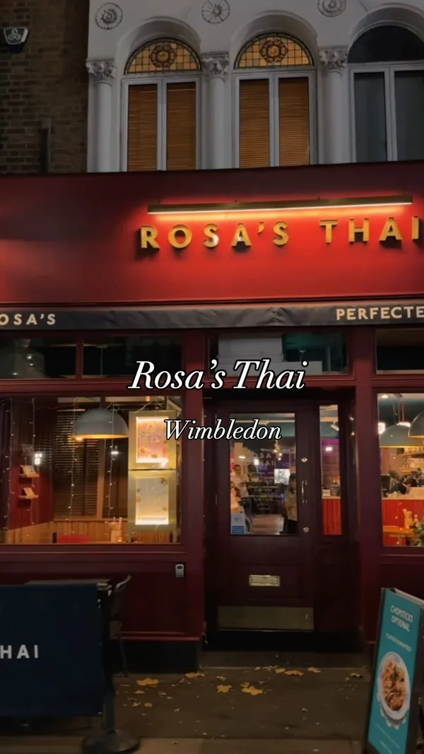 The video showcases a meal at Rosa's Thai restaurant in Wimbledon.  It features various dishes including Thai Fried Chicken, Tod Mun Goong (prawn cakes), Gai Satay (chicken satay), Gaeng Tay Po (red curry), Pad Kra Prow (chilli & basil stir fry), and churros. The presentation emphasizes vibrant colors and appetizing close-ups of each dish.  The video mentions that only the chicken is Halal. The main focus is on the food and dining experience, with a brief glimpse of the restaurant's interior and ambiance.