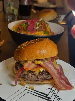 Delicious burger and massive sides at Prime by Pasture in Bristol, known for outstanding flavors and atmosphere.