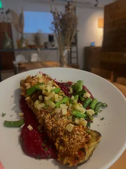 Brunch dish at The Magic Hat Cafe: allotment special with stuffed marrow, beetroot borani, fried beans, and pickled rhubarb.