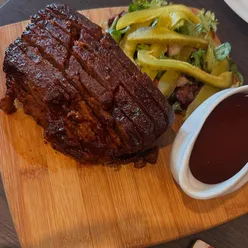 Delicious brisket dish enjoyed at The Queen Inn in Cwmbran, featuring a cute Labradoodle.