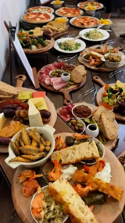 Delicious spread from The Farmer's Table at Greenmeadow Farm, featuring pizzas, polenta chips, and seafood platters.